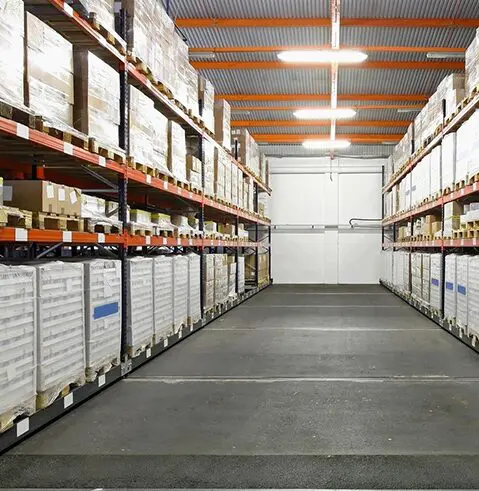 A warehouse with many shelves of boxes and papers.